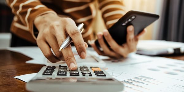 Female accountant or banker making calculation of finance and economy banking concept.